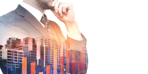 Business person with a hand on their chin with some office buildings and bar graphs superimposed on their shirt