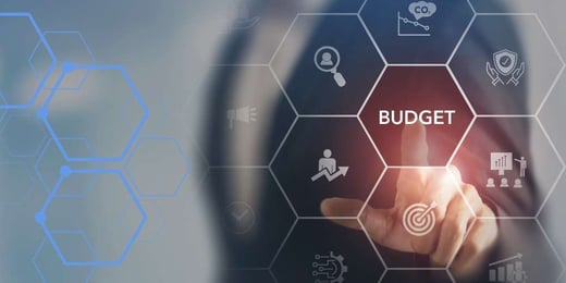 Business executive selecting “budget” on a digital interface, symbolising technology investment decisions, cost management and strategic planning.